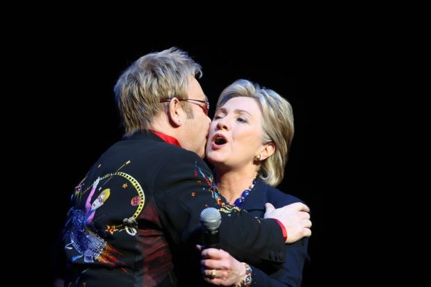 British songwriter Elton John embraces Democratic presidential contender Hillary Clinton at a fundraiser at Radio City Music Hall on April 9, 2008. - Photo by Andrew Theodorakis-Pool/Getty Images