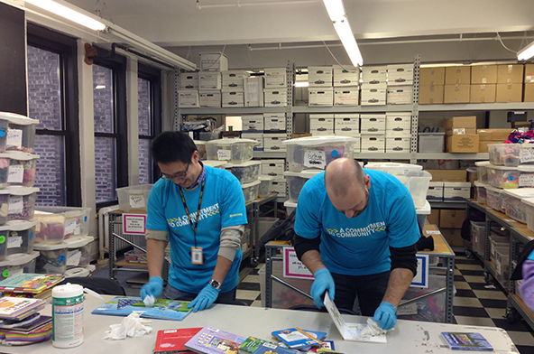 Employees at Baby Buggy help sort and bundle items that will be donated to underserved families (books, clothing, toys for children)