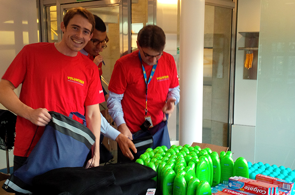 Employees in Switzerland help assemble warm winter kits to be donated to underserved families.