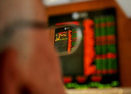 A graph showing the progress of the Australian Securities Exchange is refracted in the glasses of an investor at the Australian Securities Exchance (ASX) in Sydney, Australia, on Wednesday, Jan. 23, 2008. Shares rebounded on opening today at the ASX following a slump in global markets. Photographer: Ian Waldie/Bloomberg News