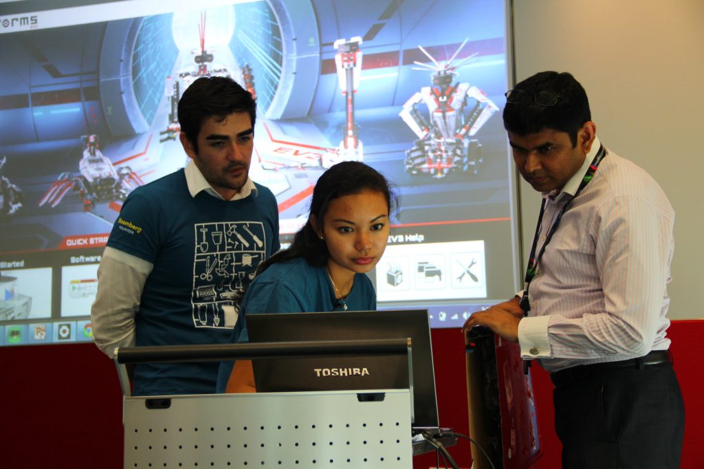 Adelaida (center) and colleagues lead a Bloomberg Startup robotics workshop for local students in the Singapore office.