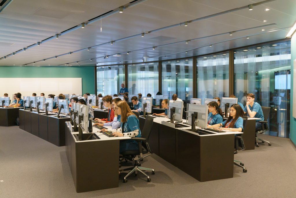 Bloomberg interns sit at computers